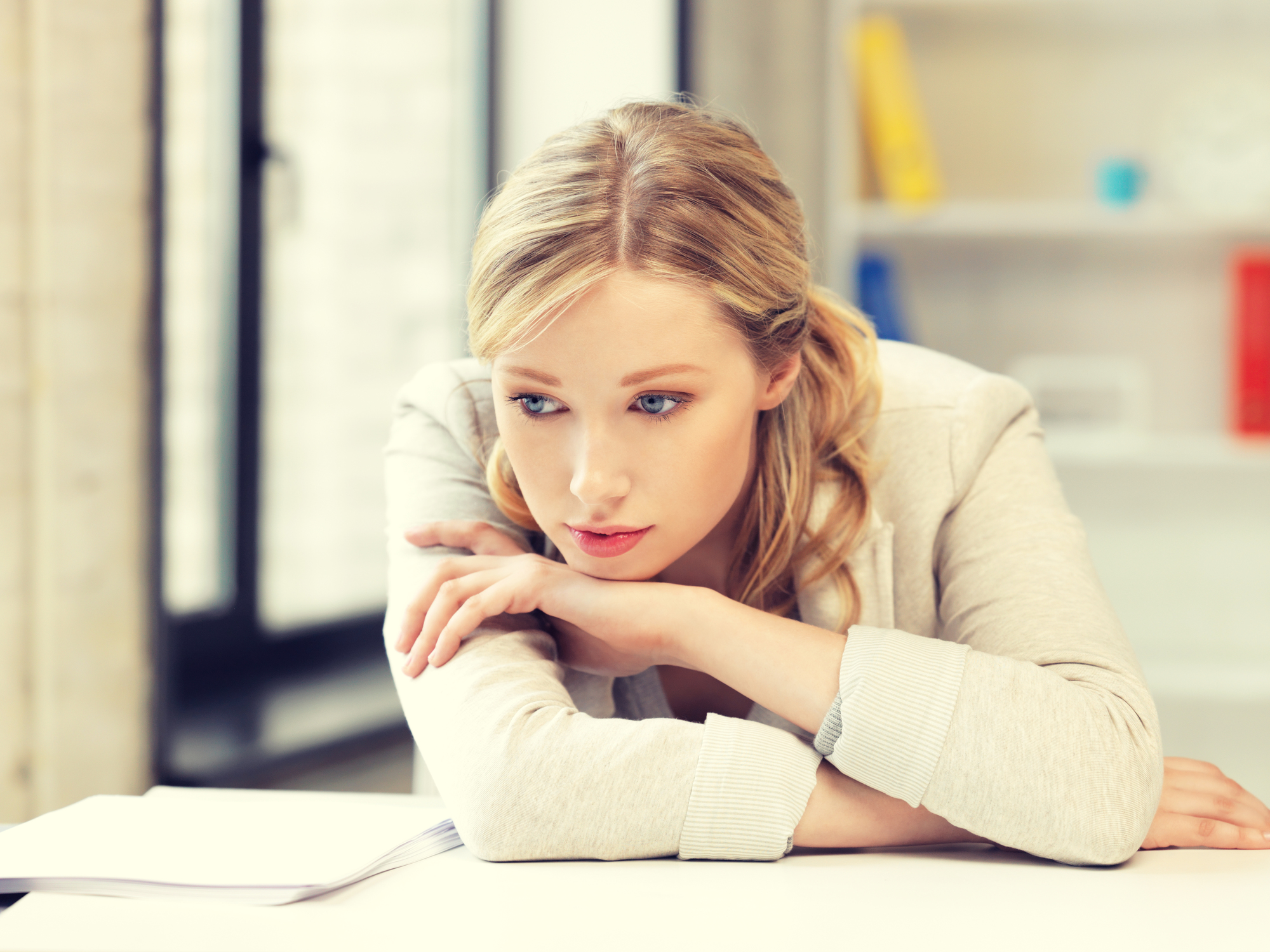 bright picture of unhappy woman in office