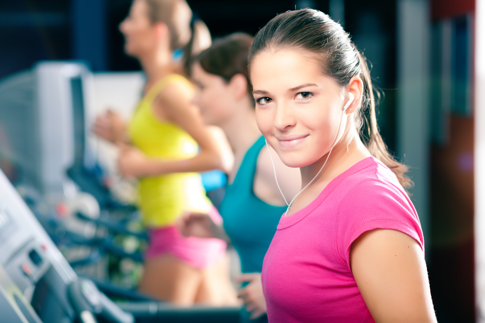 Running on treadmill in gym - group of women exercising to gain more fitness