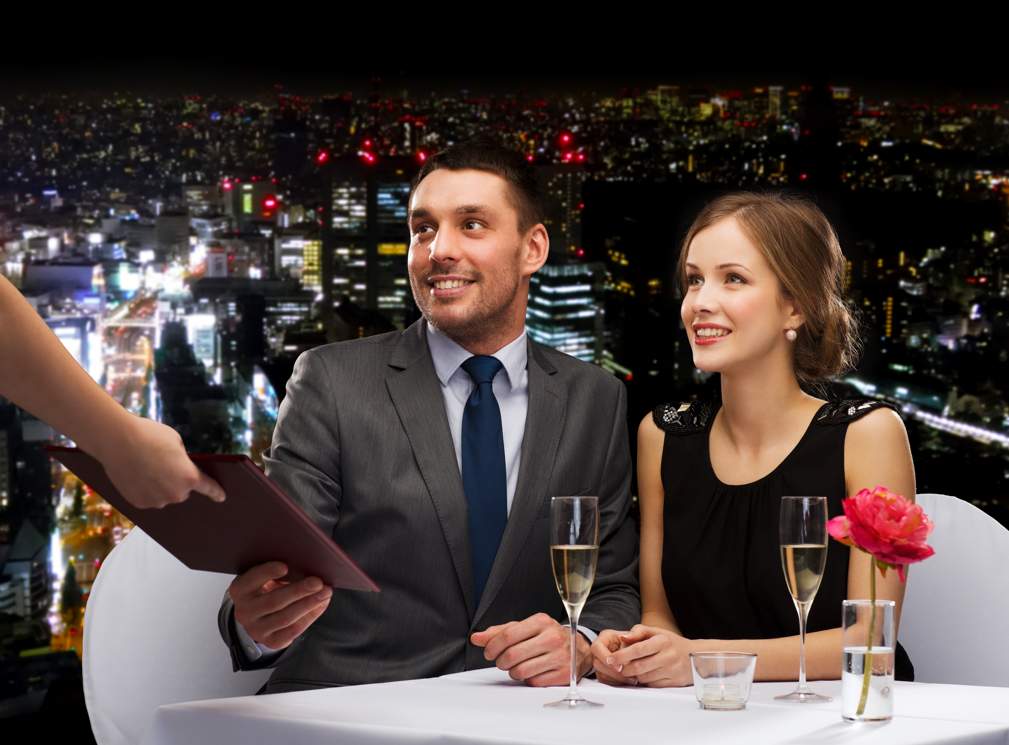 restaurant, couple and holiday concept - waiter giving menu to happy couple at restaurant