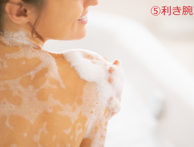 Closeup on young woman washing in bathtub. rear view