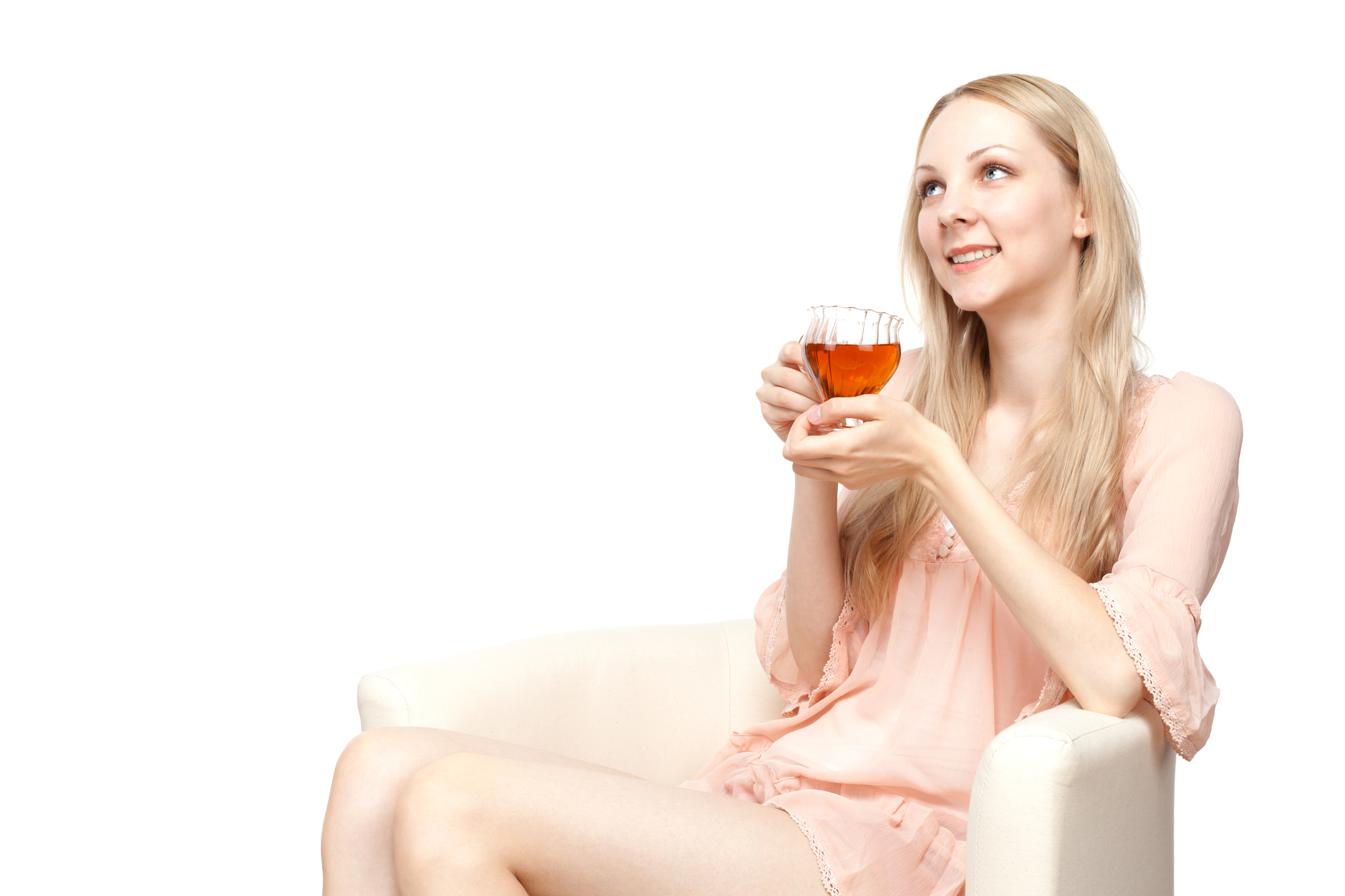 Beautiful young woman drinking tea sitting