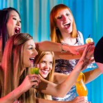 Friends watching striptease in strip club grabbing at female stripper