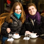 Happy young couple in a Parisian street cafe