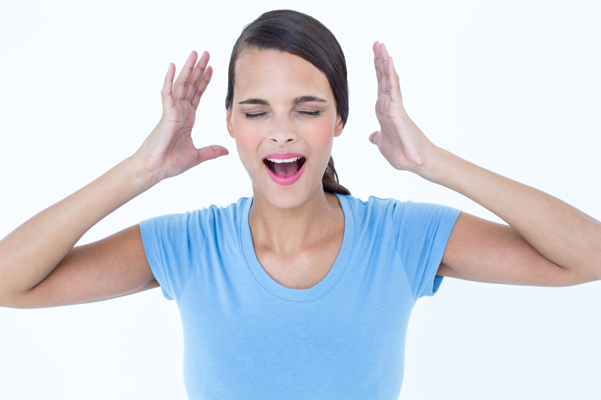 Stressed woman raising her hands around her head on white background