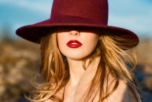 Portrait of elegant beautiful woman with red lips and hat